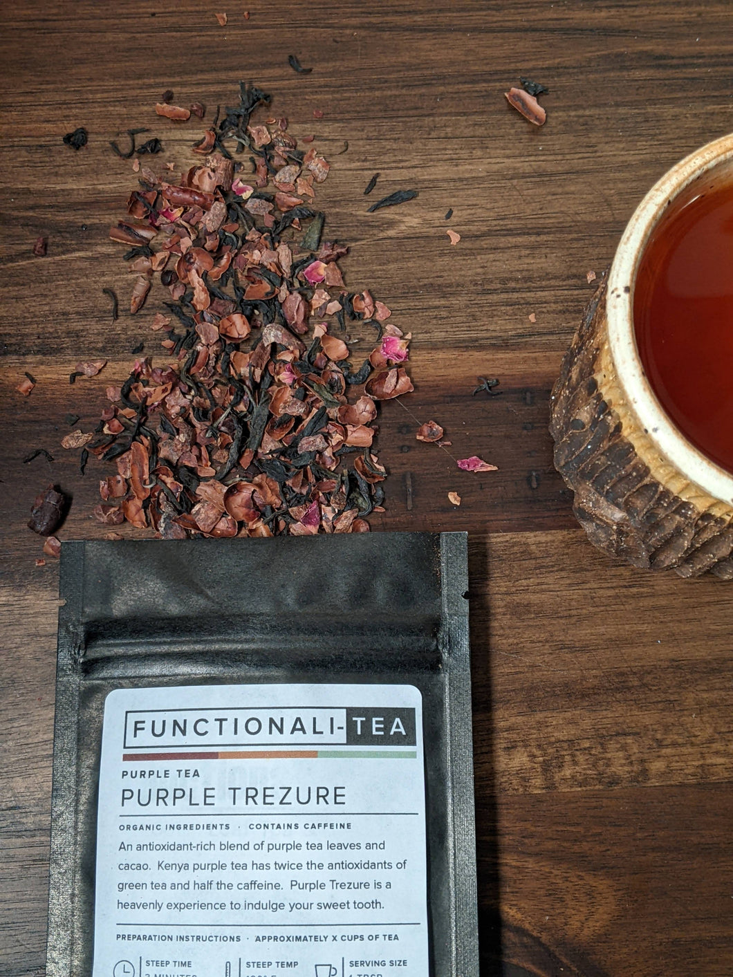 Purple Trezure tea coming from tea bag and tea cup