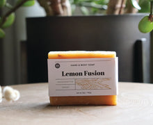 Load image into Gallery viewer, Lemon Fusion hand and body soap bar on a stand. handcrafted, vegan. Olive Seed
