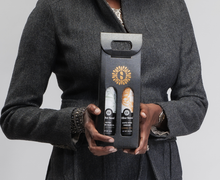 Load image into Gallery viewer, Woman holding black olive oil and vinegar gift set with Olive Seed brandmark.
